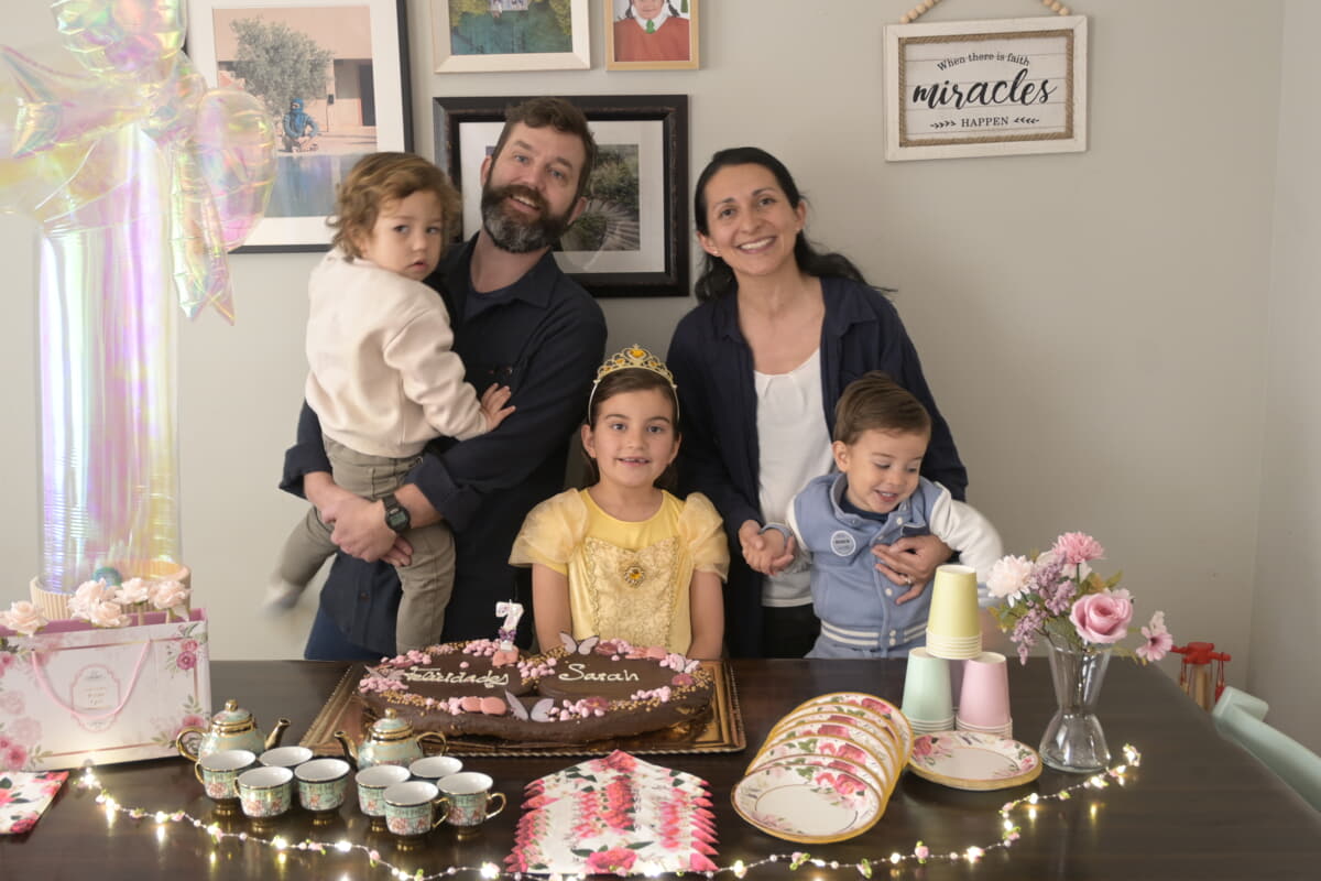 Sarah with her family and cake